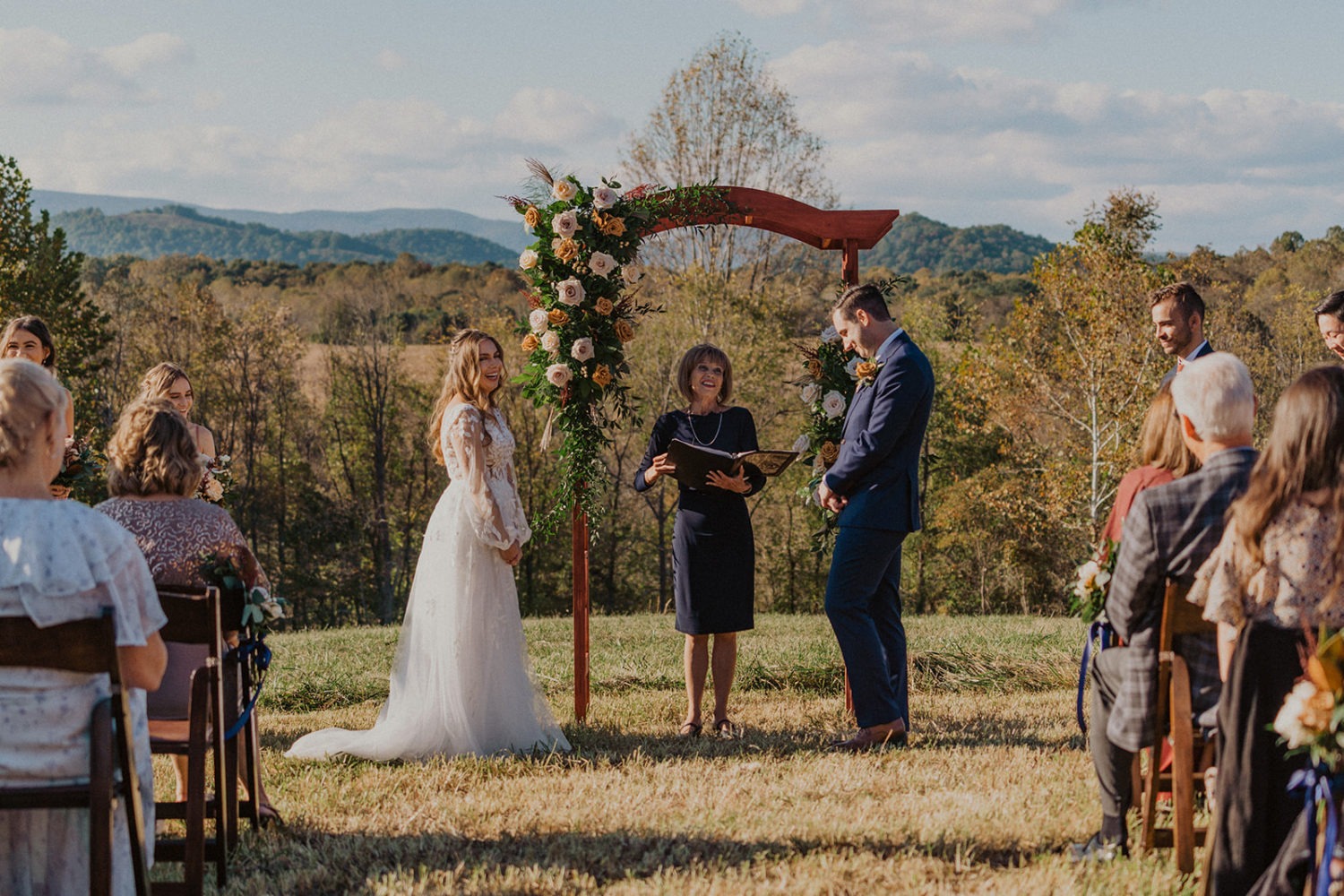 Couple laughs while exchanging vows at mountainside wedding ceremony