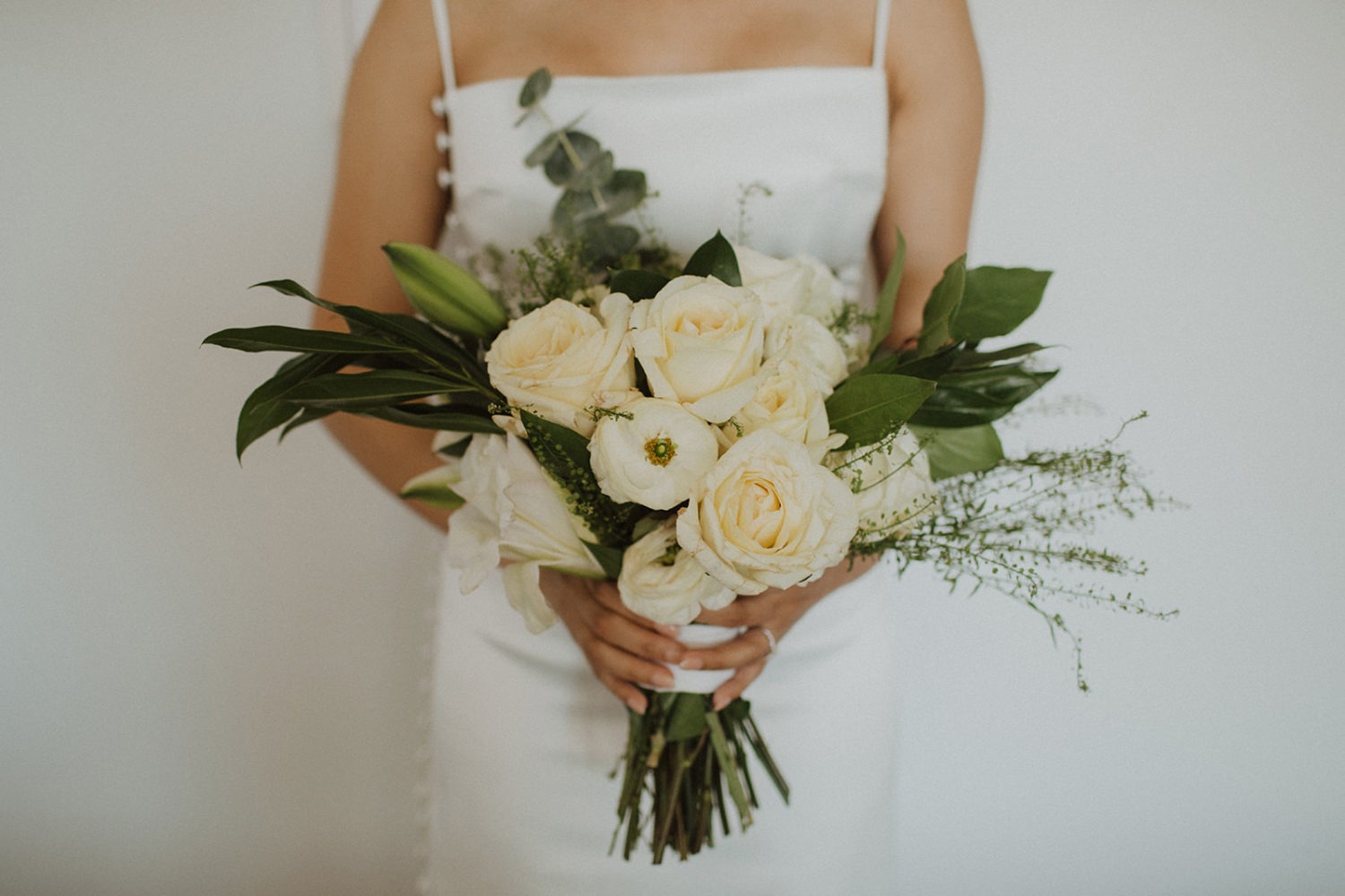 Bride holds wedding bouquet at DC rooftop hotel elopement