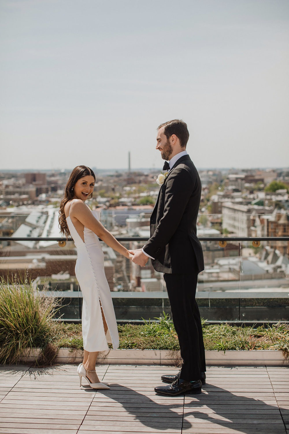 Couple holds hands at DC rooftop elopement