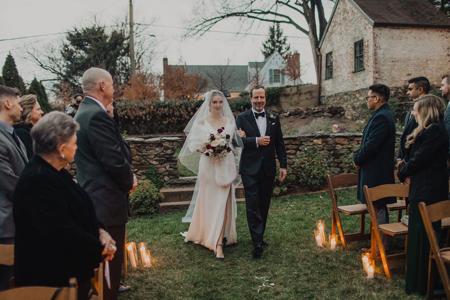 Bride walks down aisle with dad at intimate wedding