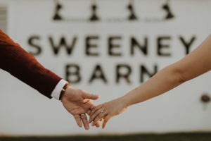 Couple holds hands outside of Virginia barn wedding venue
