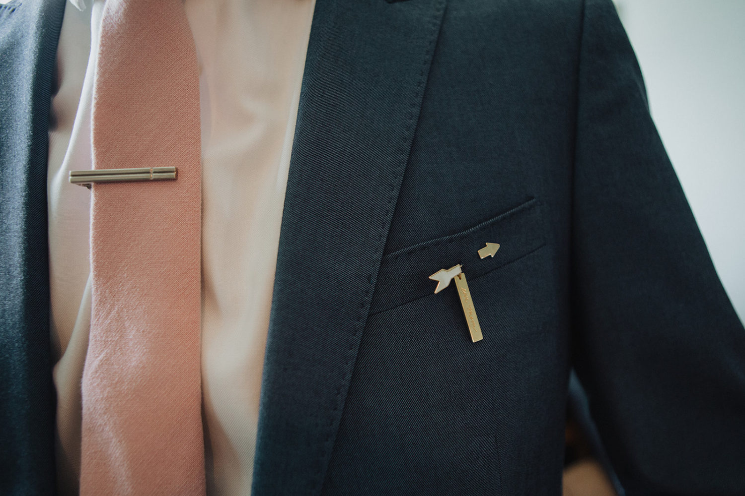 Groom's tie pin on tie and personalized pin on suit jacket 