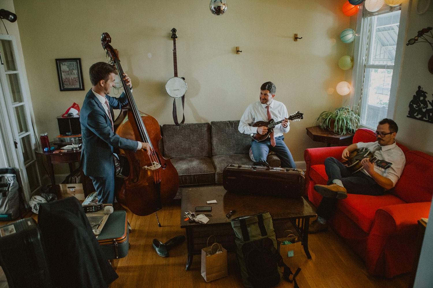 groom plays bass while jamming with groomsmen 