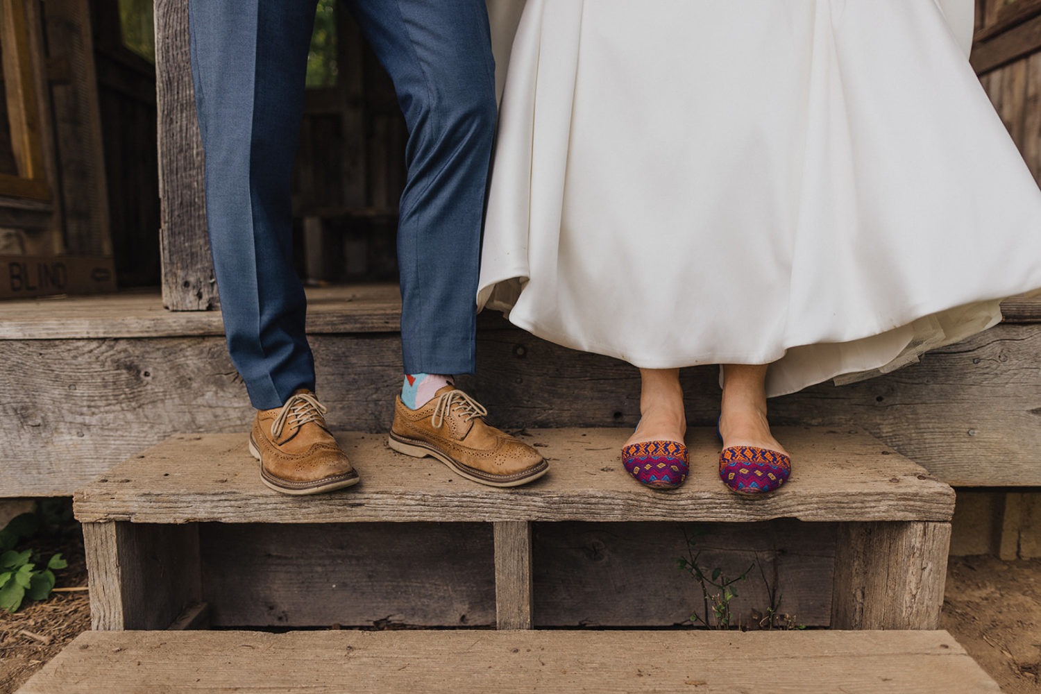 Bride and groom shoe off their colorful wedding shoes and socks