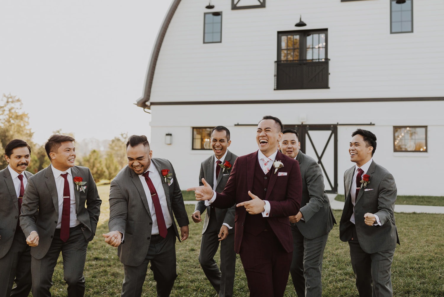 Groomsmen laugh together at Virginia barn wedding