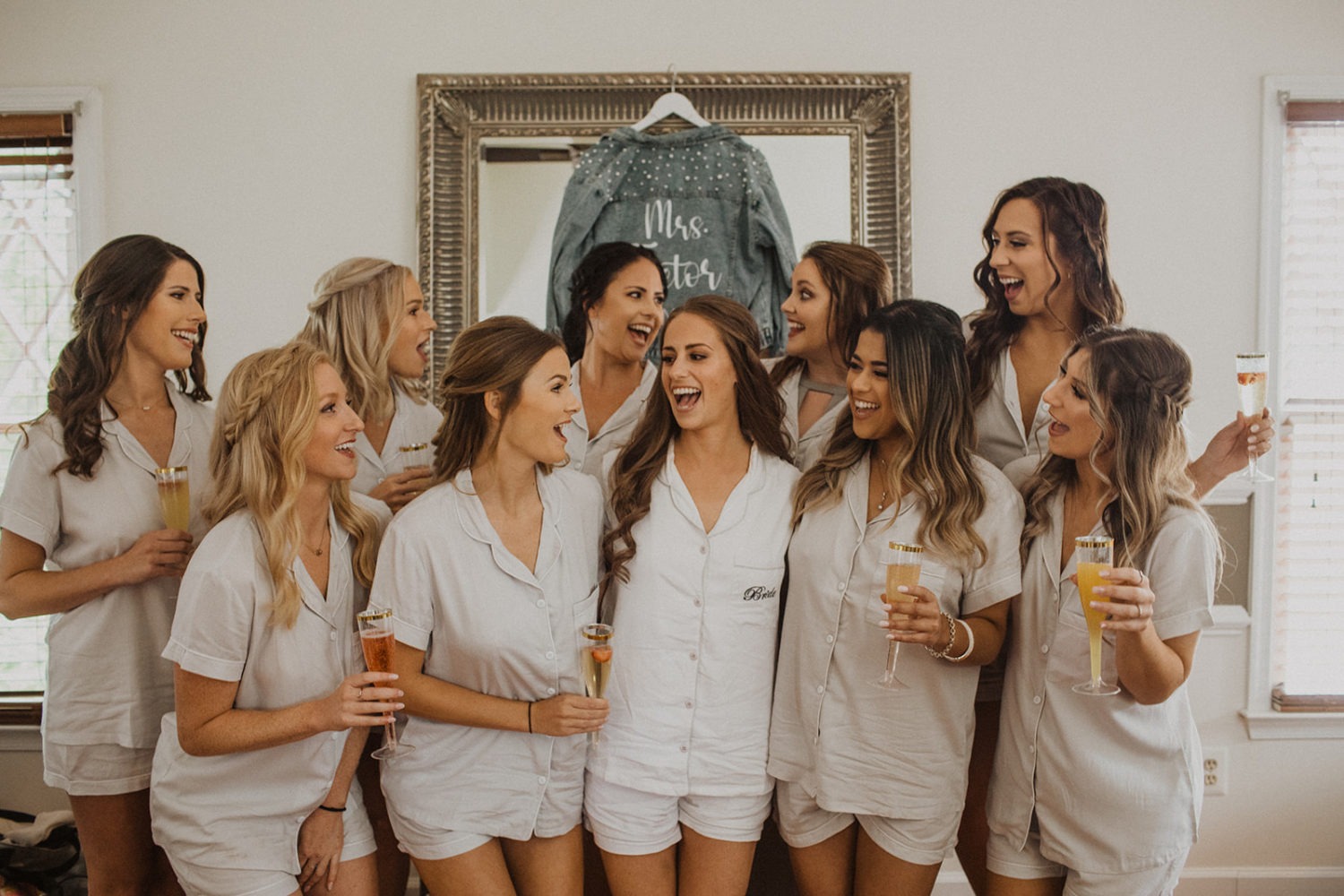 Bride drinks champagne with bridesmaids using best wedding day tips
