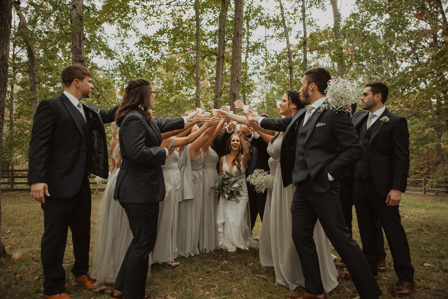 Couple cheers with wedding party using best wedding day tips