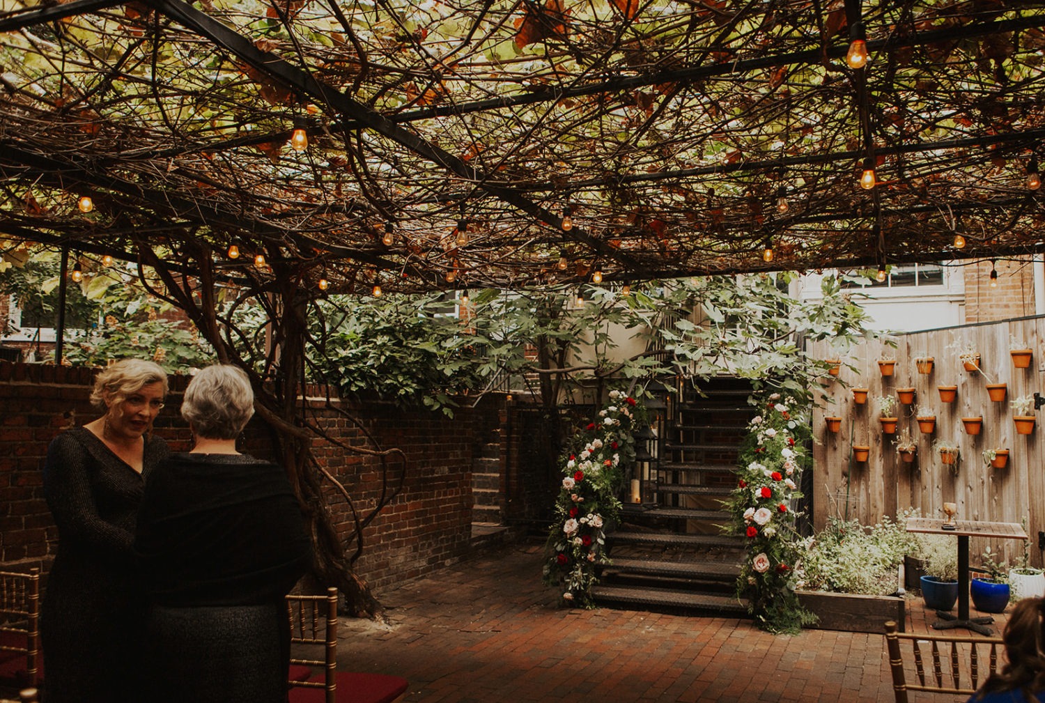 Canopy of ivy covers wedding ceremony space at Iron Gate Restaurant DC wedding