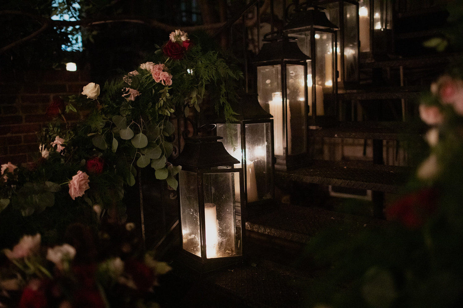 Glowing lit lanterns sit on staircase at Iron Gate Restaurant DC wedding