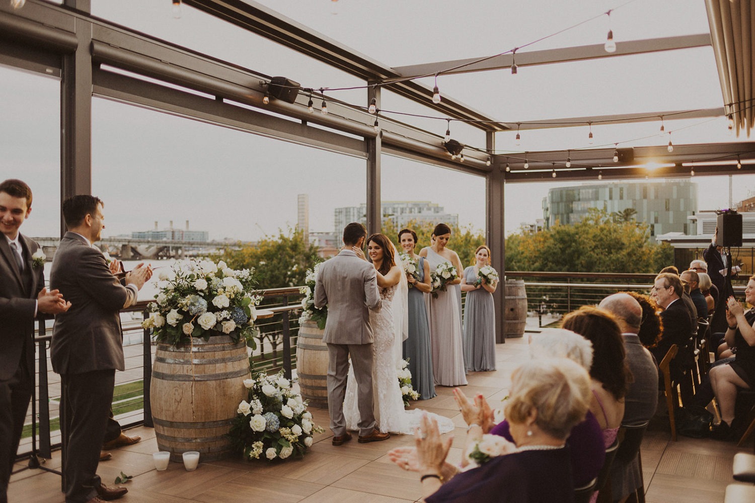 Couple embraces at rooftop wedding ceremony