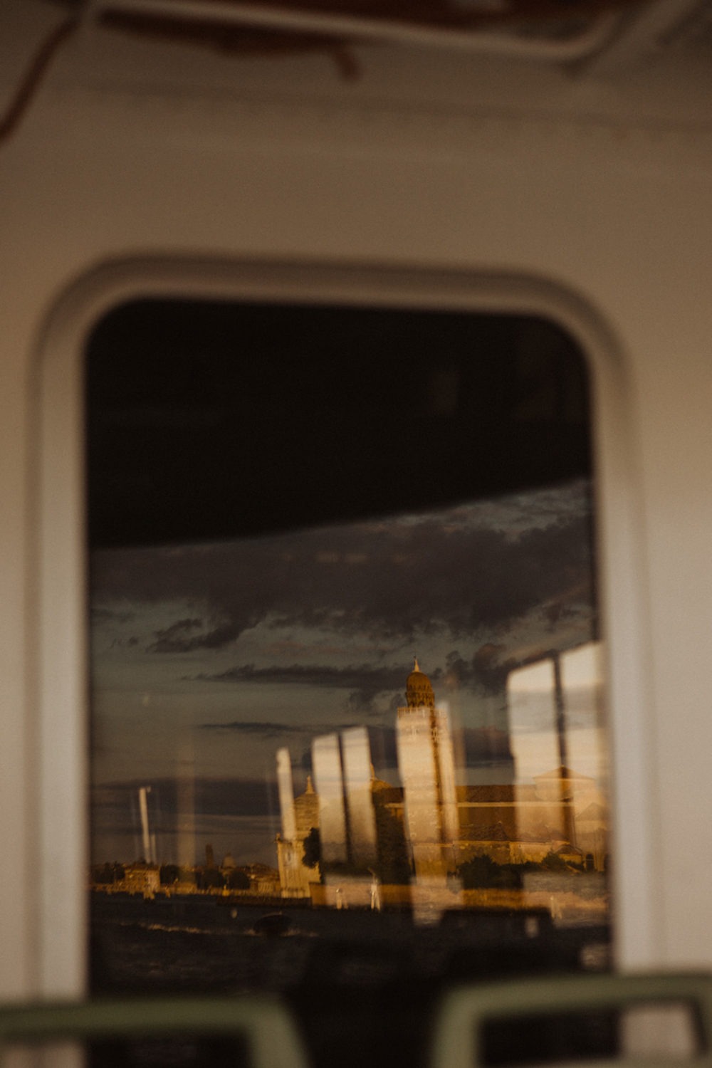 Reflection of city through train window captured by destination wedding photographer