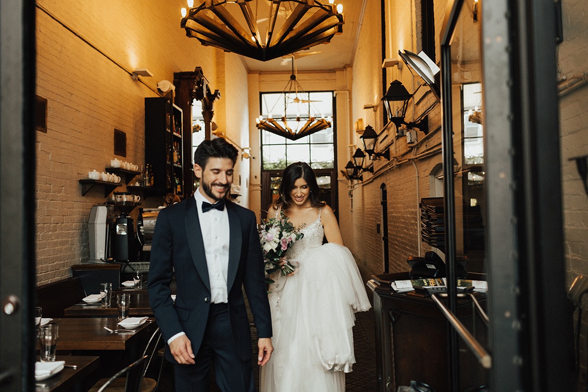 Couple walks through wedding venue restaurant 