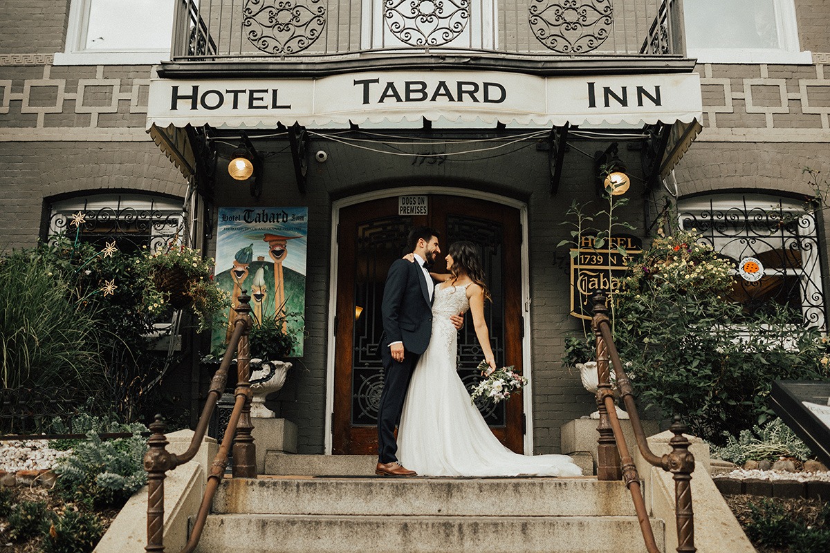Couple embraces in front of one of the best wedding venues in dc: Tabard Inn