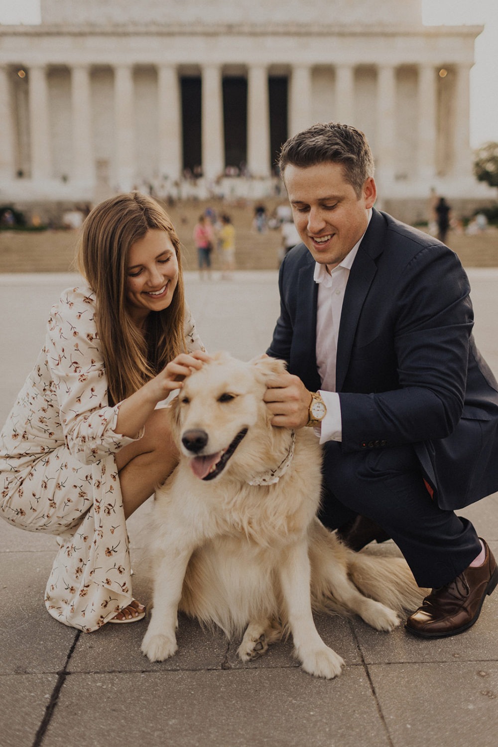 Couple pets dog at Lincoln Memorial engagement session