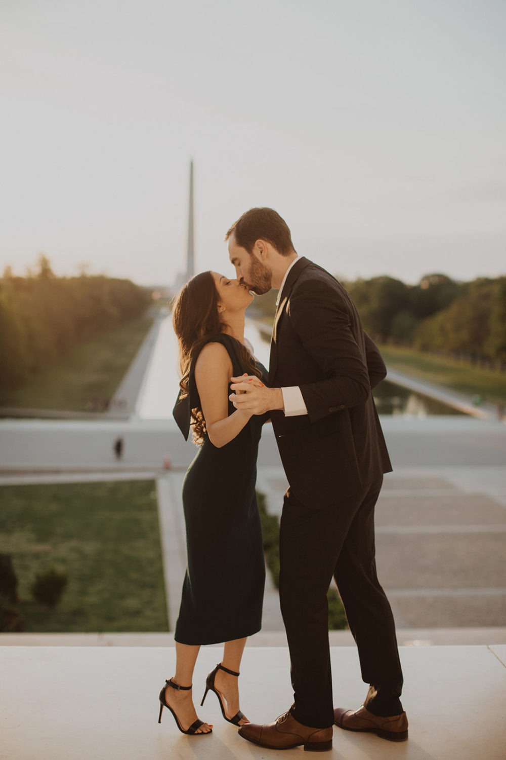 Couple kisses at Lincoln Memorial at sunrise