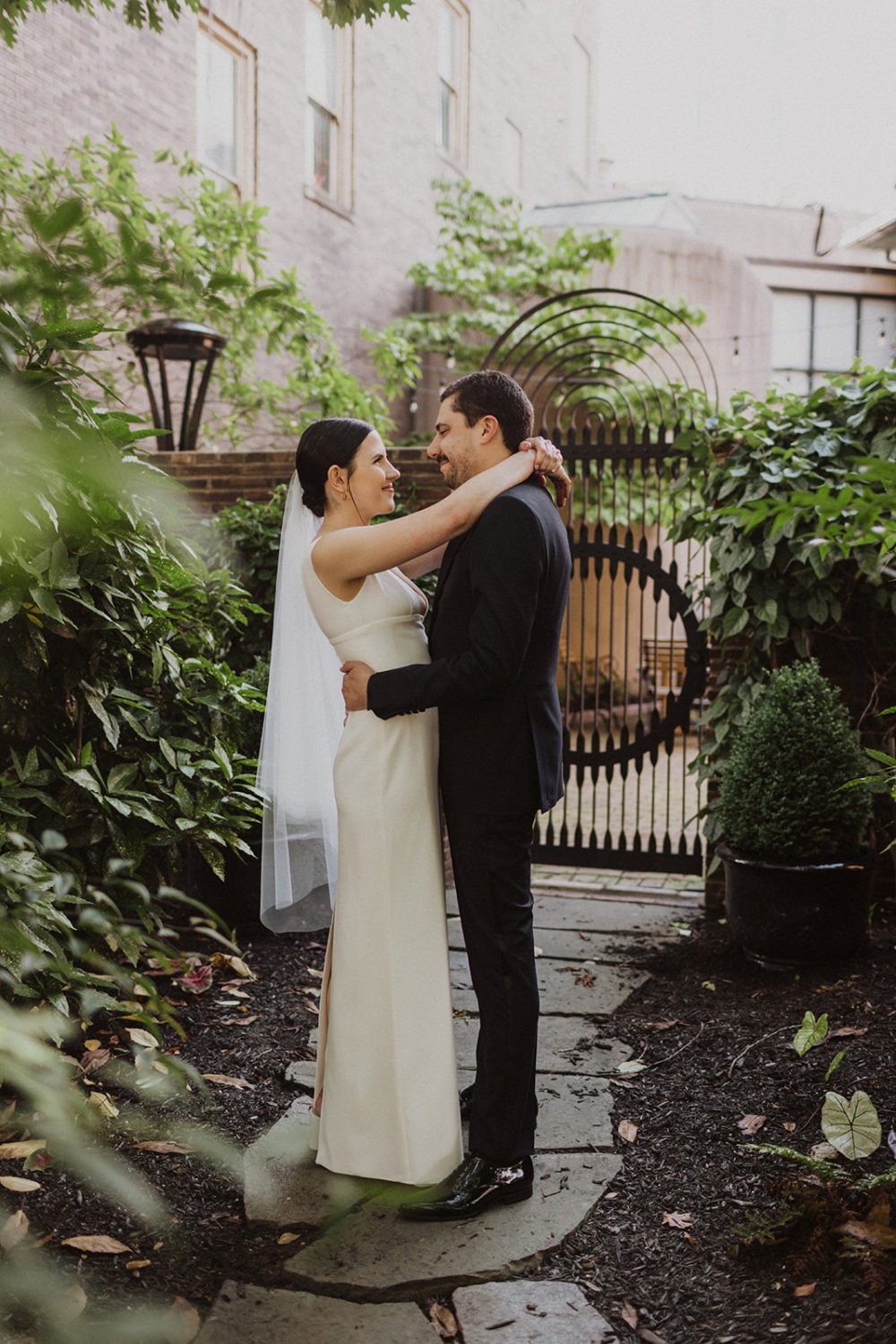 Couple embraces in garden in Dupont Circle