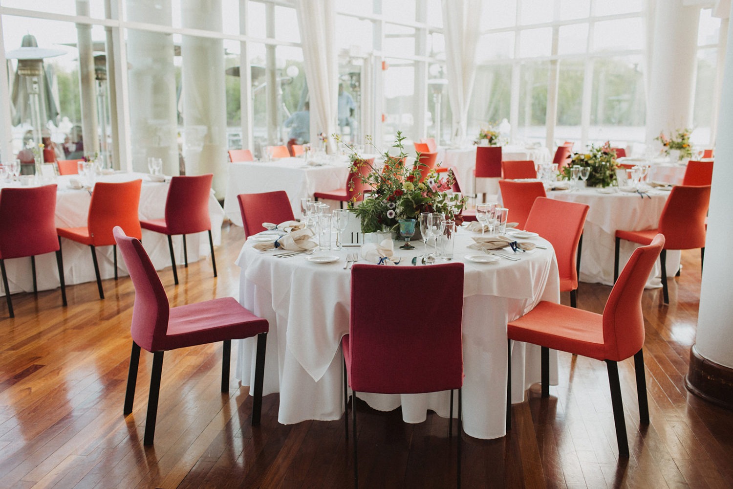 Table settings and florals on tables at Sequoia Restaurant wedding reception 