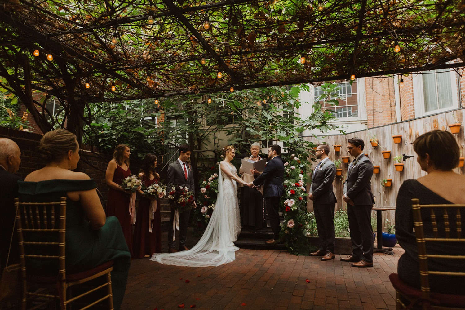 Couple exchanges vows under ivy covering at DC wedding