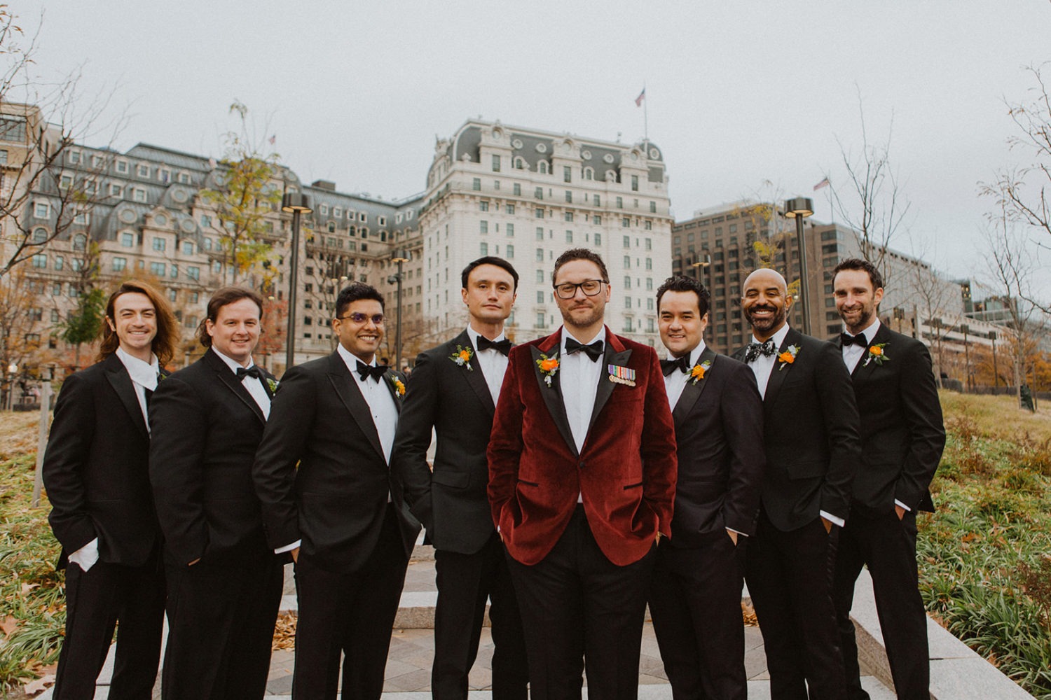 Groomsmen pose together with hands in pockets at Washington DC wedding