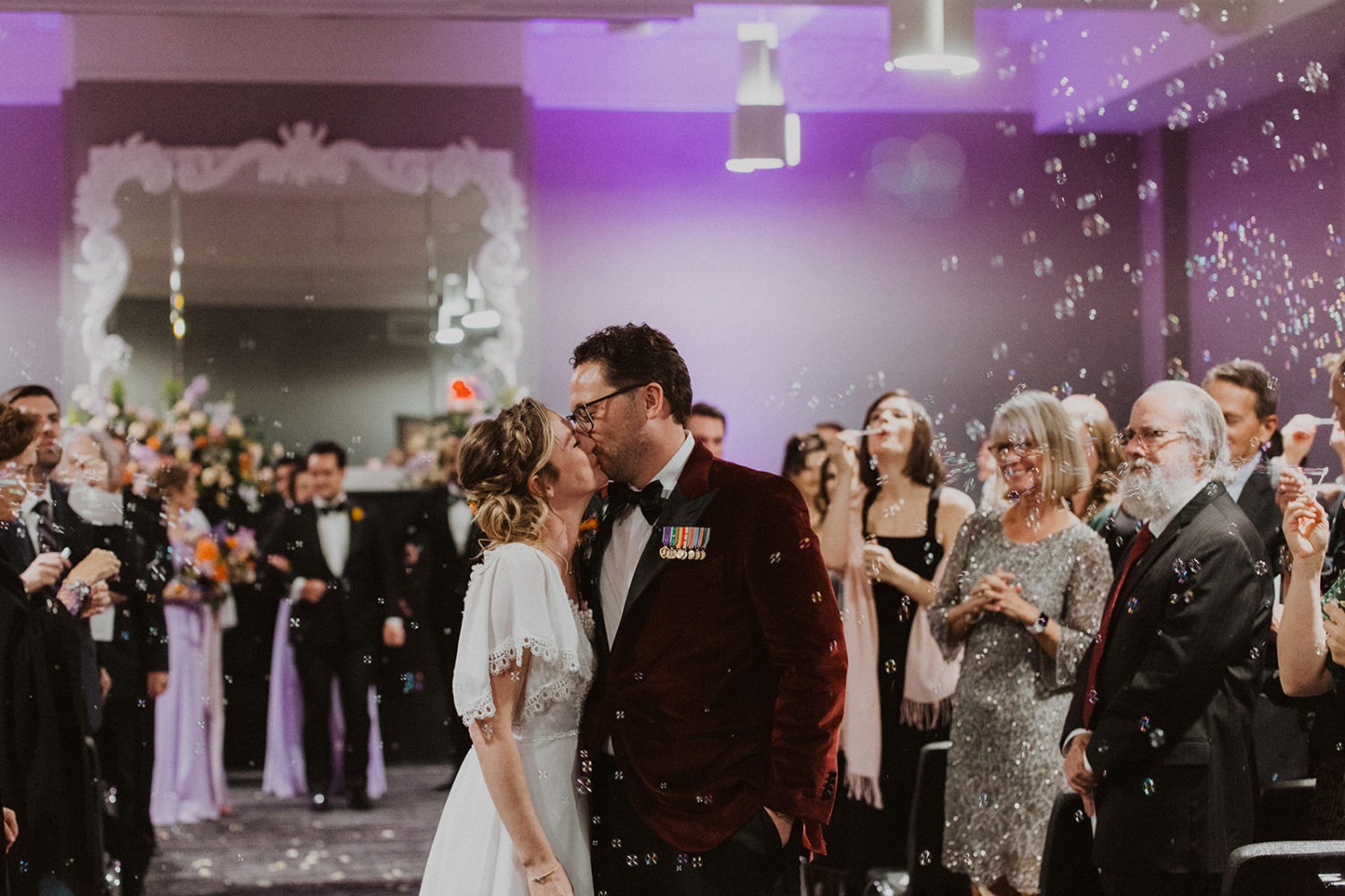 Couple kisses walking down aisle at Hotel Washington, Washington DC wedding
