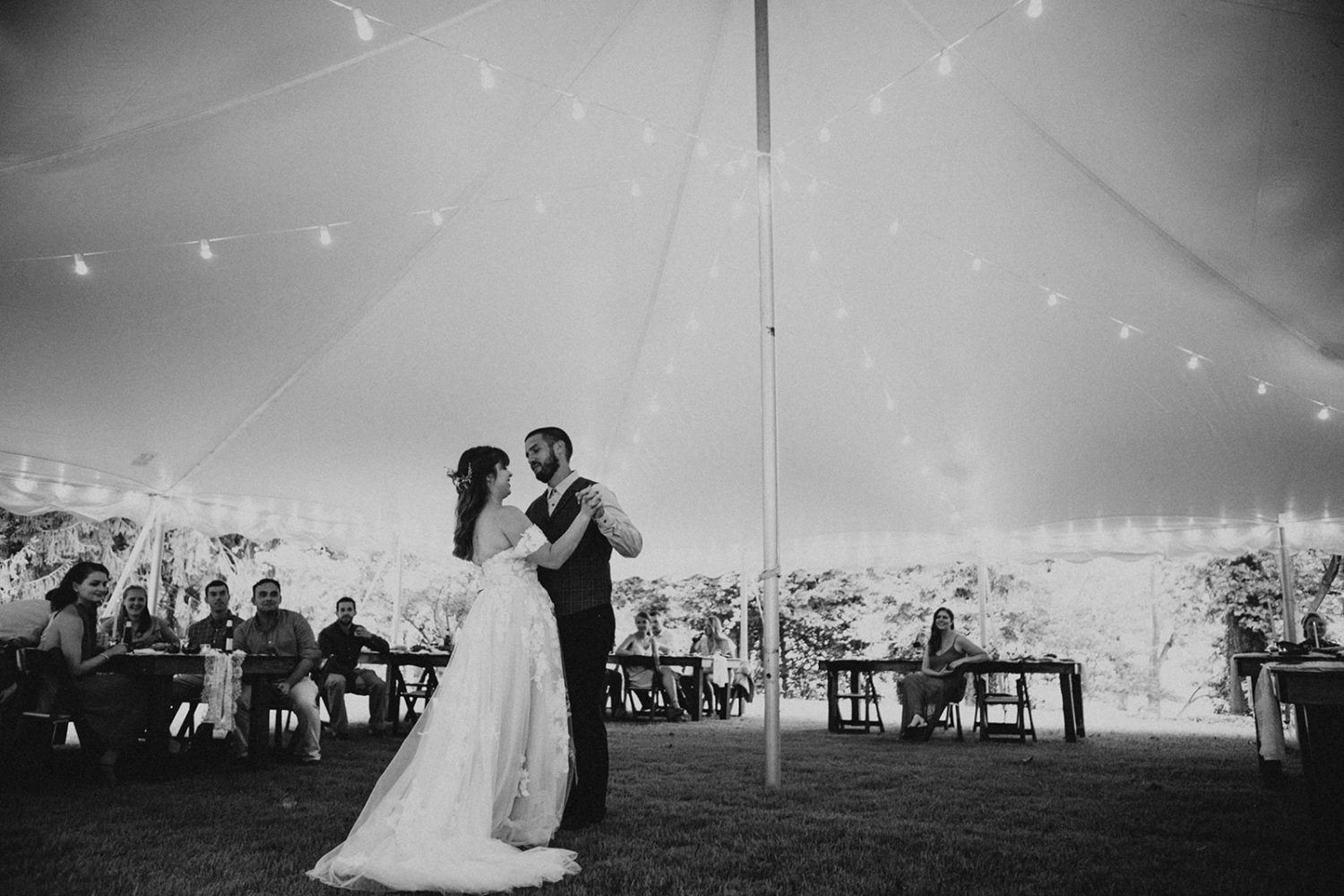 Couple dances under tent at backyard wedding