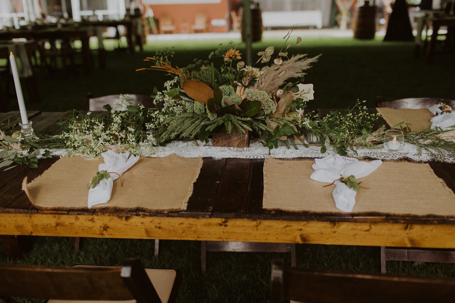 Green wedding florals on reception table