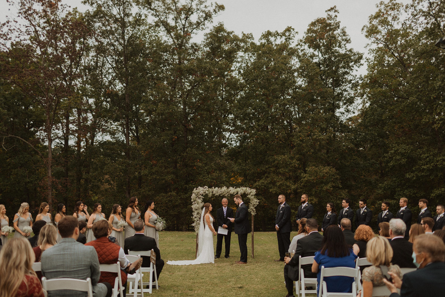 Couple stands in backyard wedding ceremony