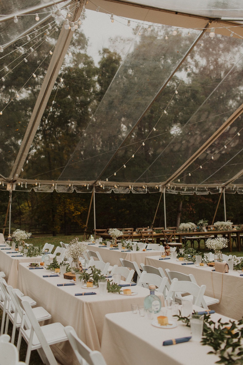 Table settings with floral decor at outdoor wedding reception