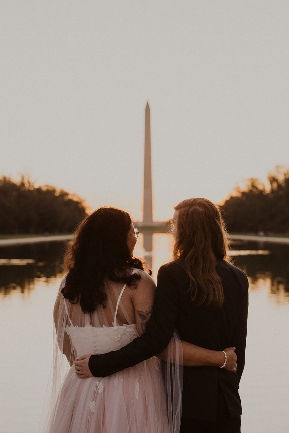 Couple embraces at Lincoln Memorial sunset session