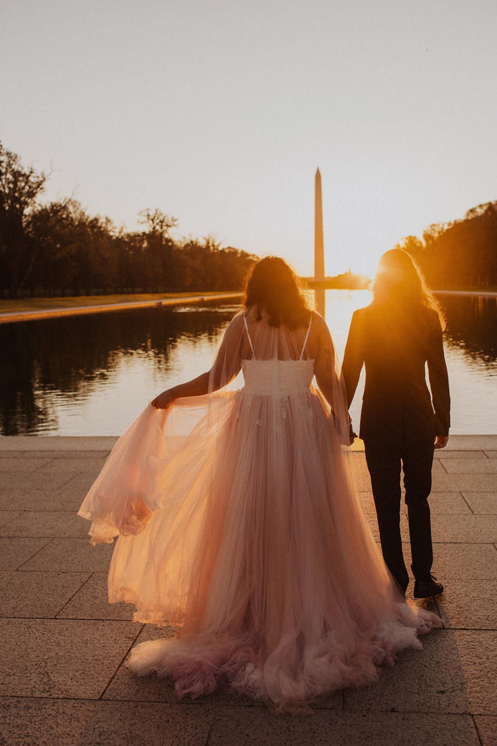 Couple holds hands at Lincoln Memorial sunset session