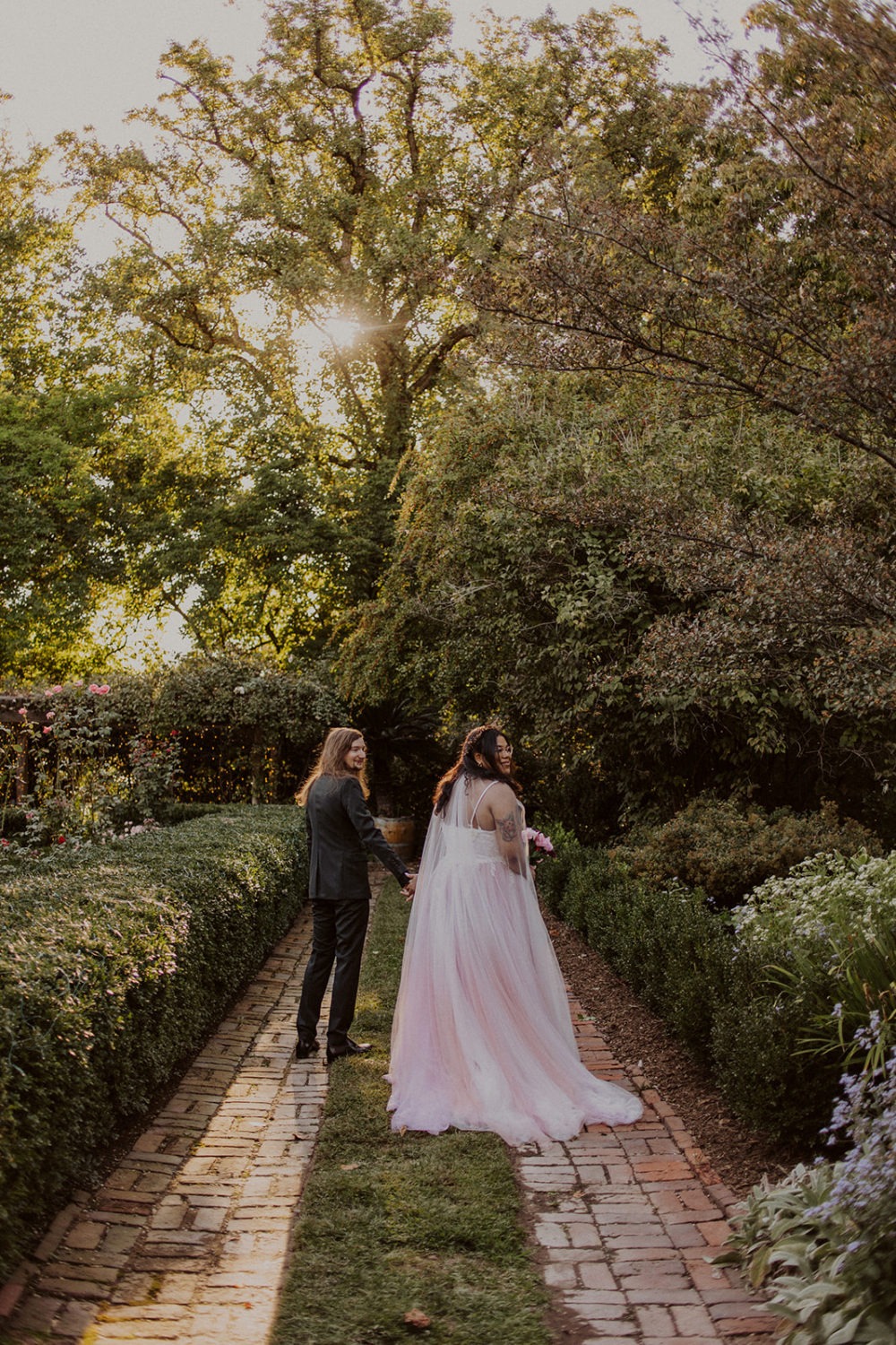 Couple walks holding hands at Washington DC garden wedding