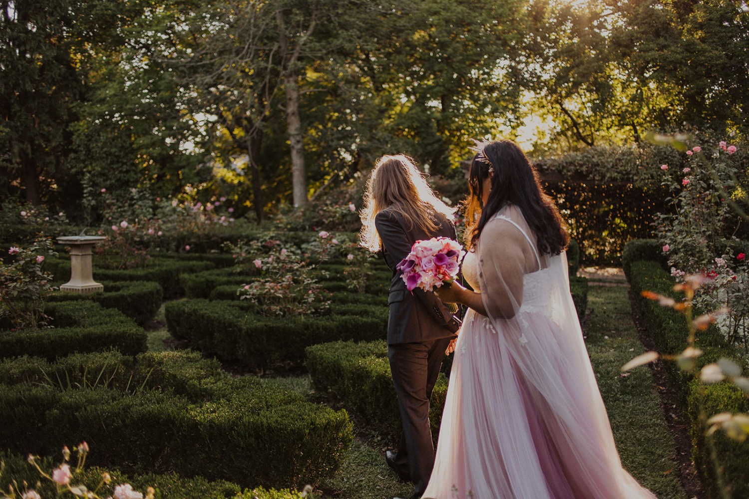 Couple walks through garden at sunset DC wedding