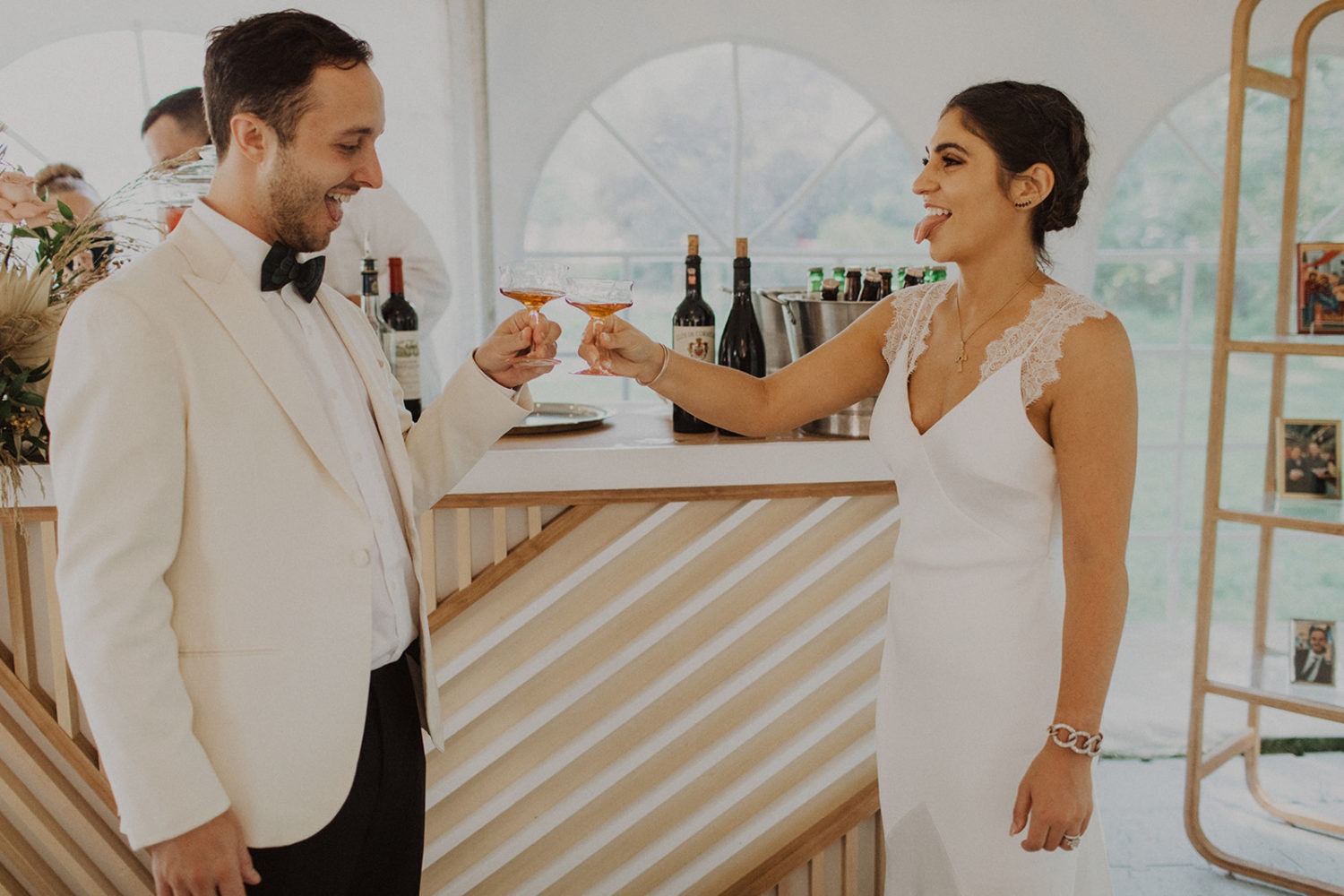Couple drinks cocktails during wedding first look