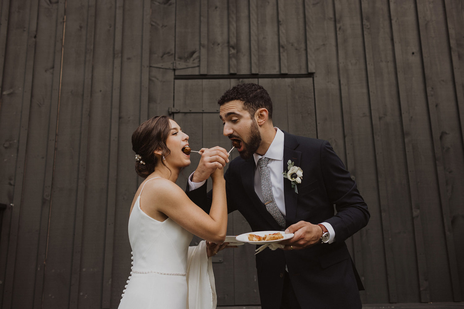 Couple eats snack during wedding first look