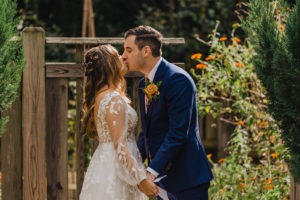 Couple kisses after vows during wedding first look