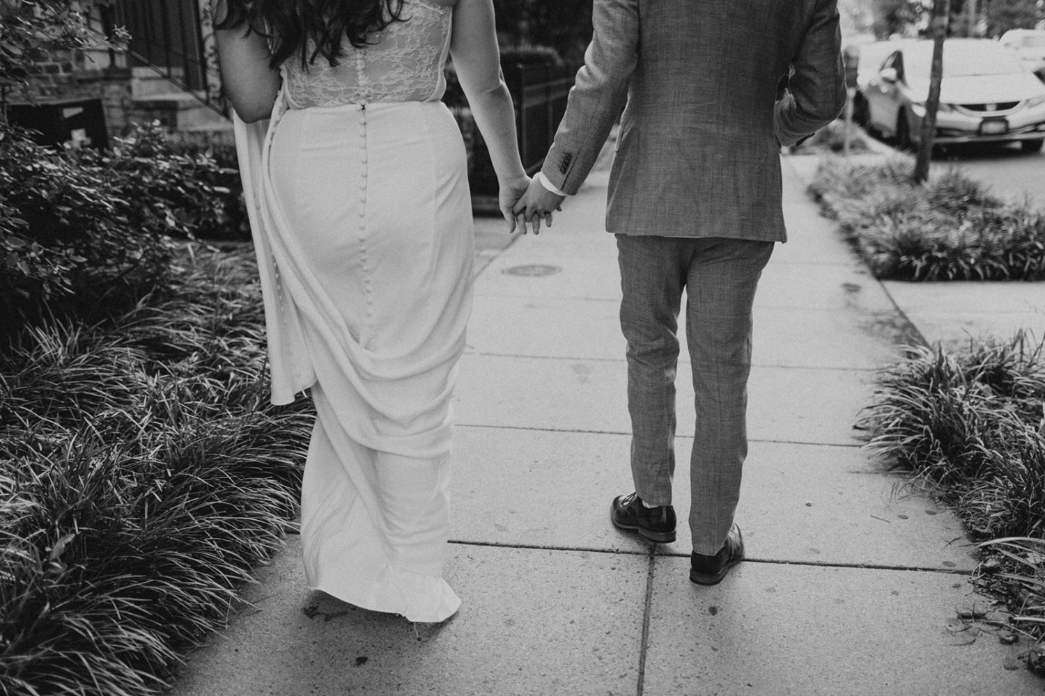 Couple holds hands walking down DC streets as part of wedding photography packages