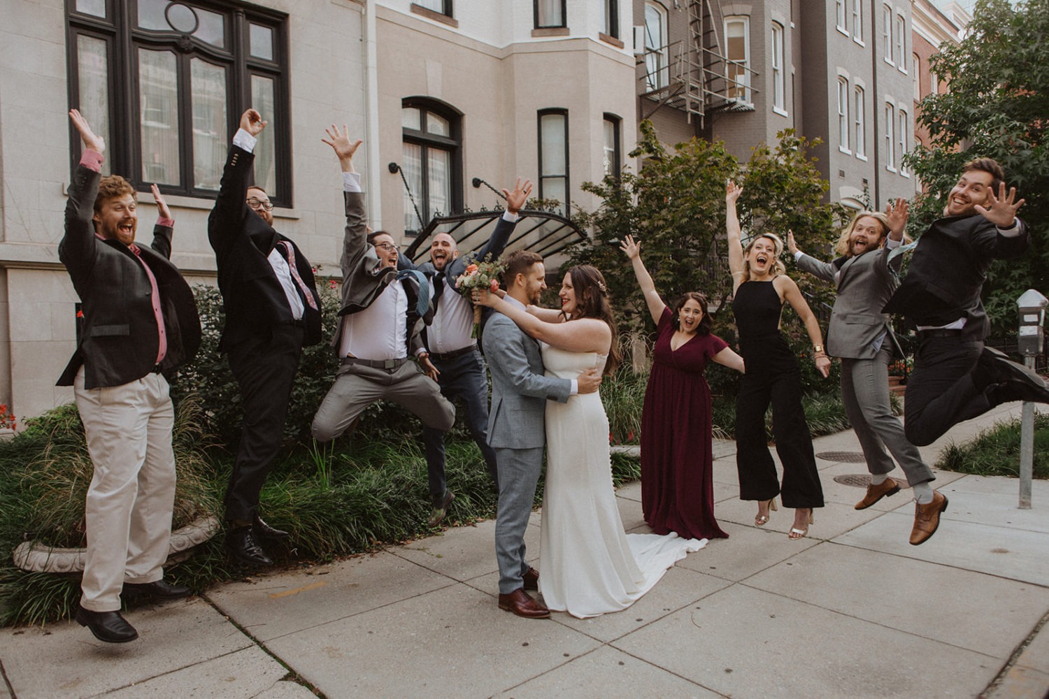 Wedding party jumps beside couple at Washington DC wedding