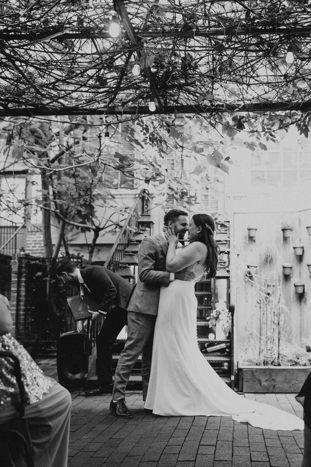 Couple kisses at garden DC restaurant wedding 