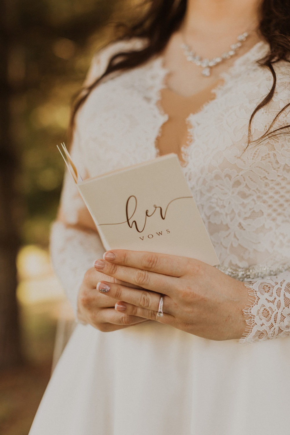 Groom holds a her vows book