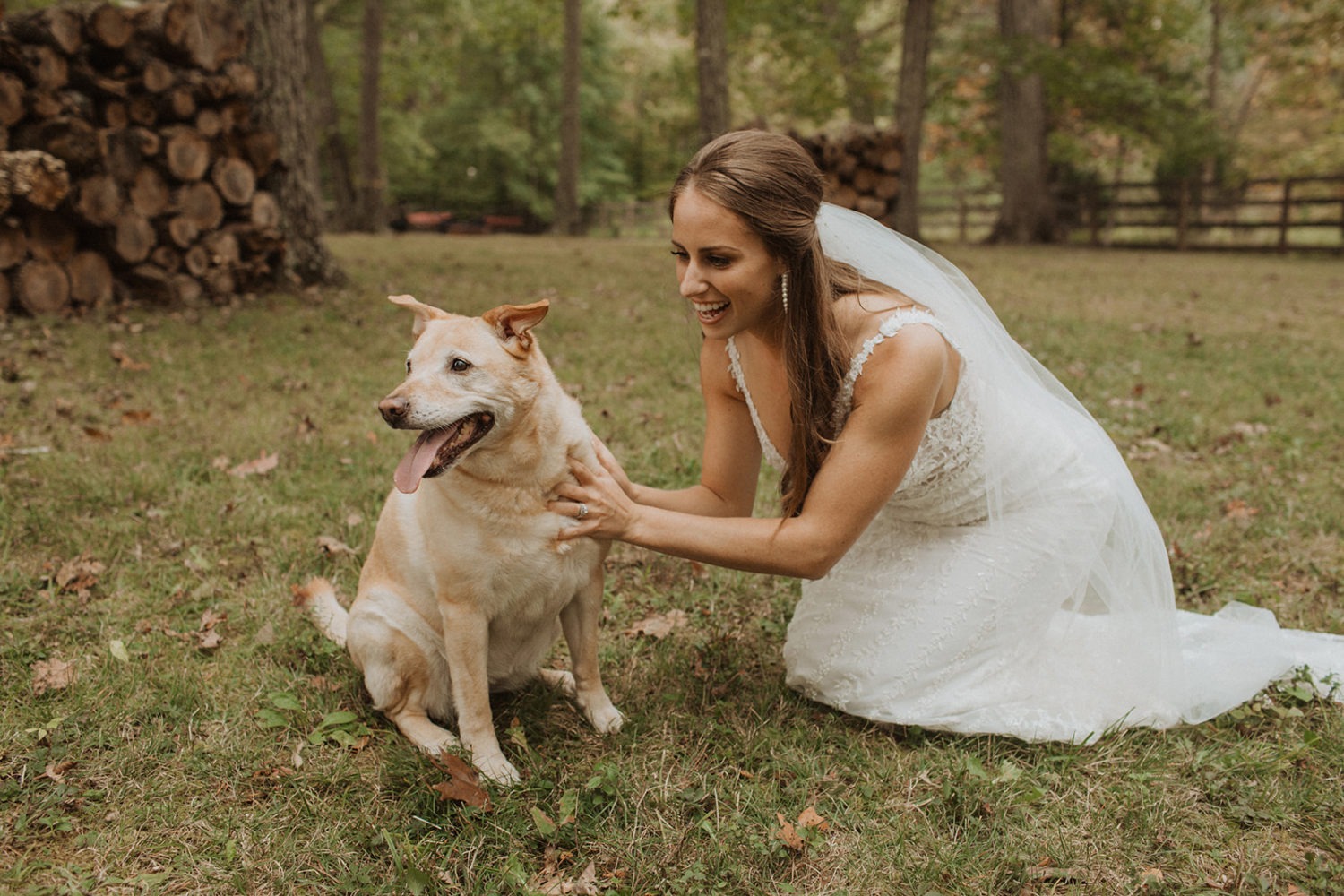 Bride pets dog on wedding day