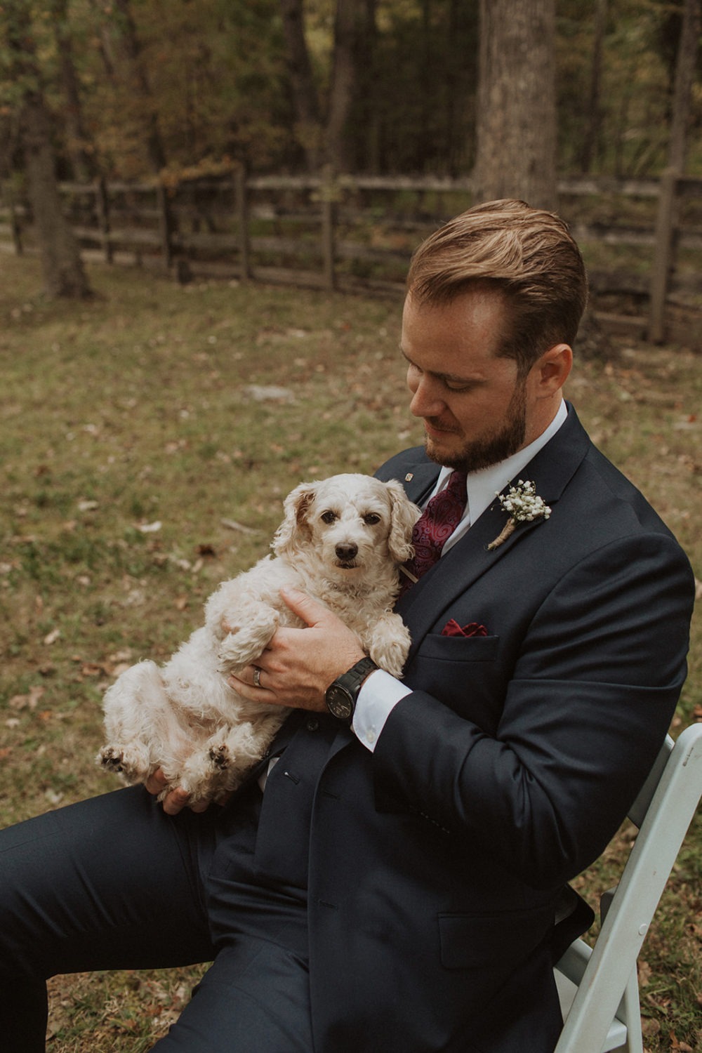 Groom holds dog on wedding day