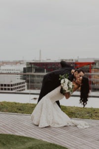 couple kisses at rooftop wedding venue