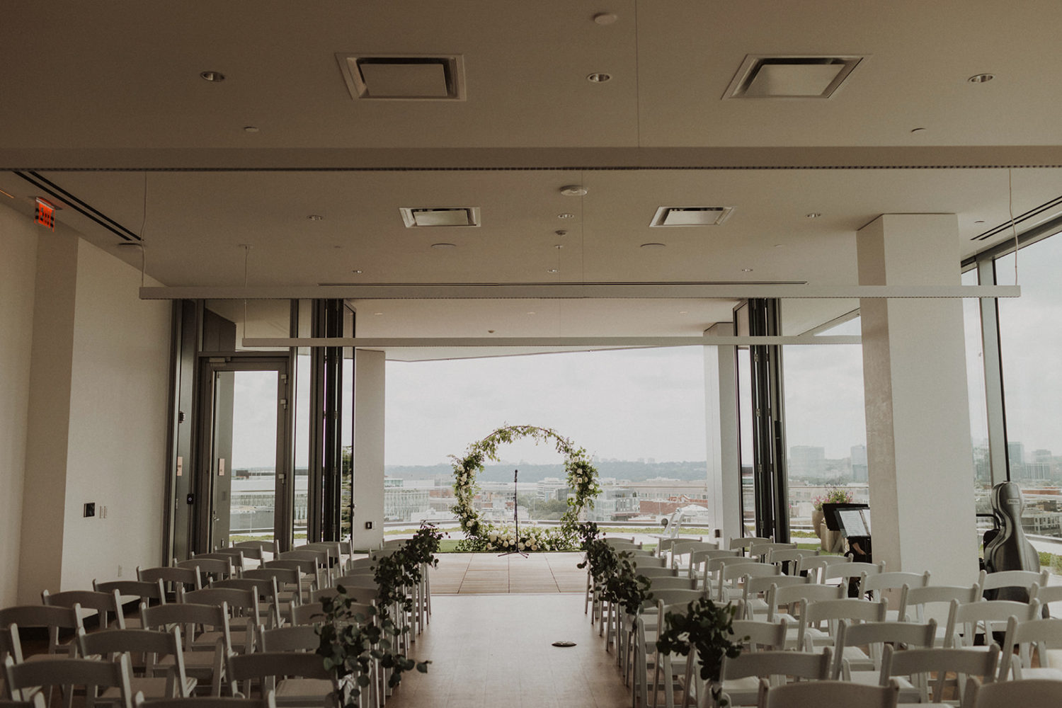 wedding ceremony white chair setup at rooftop wedding venue