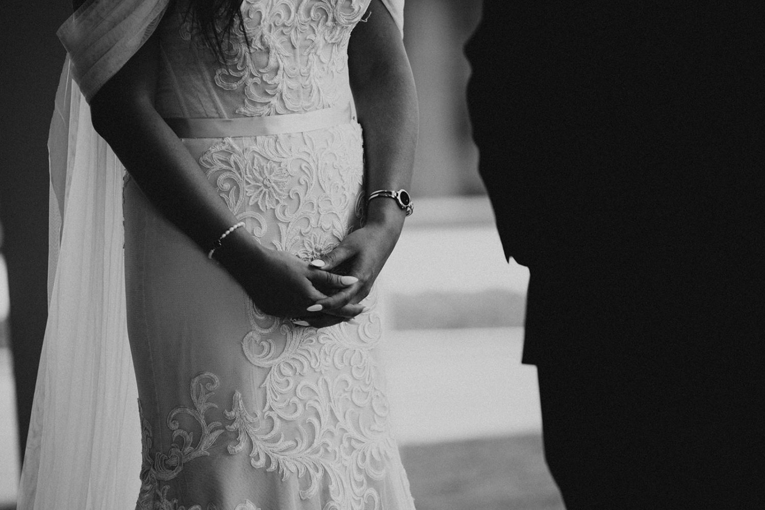 bride holds her hands during wedding ceremony