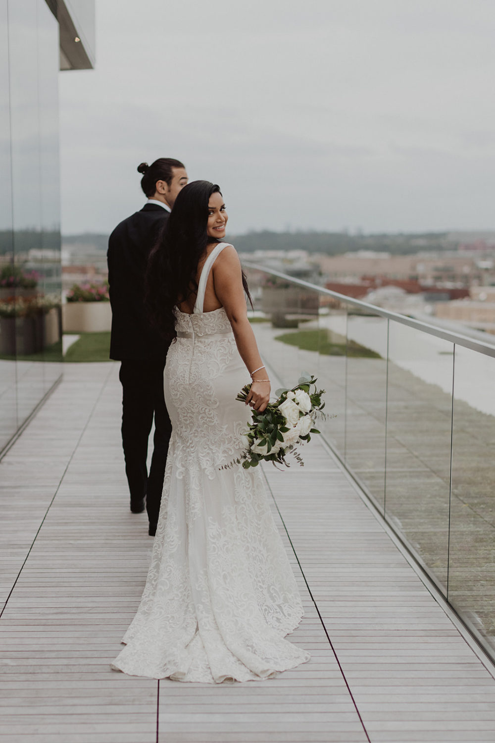 Couple walks along washington DC rooftop wedding venue