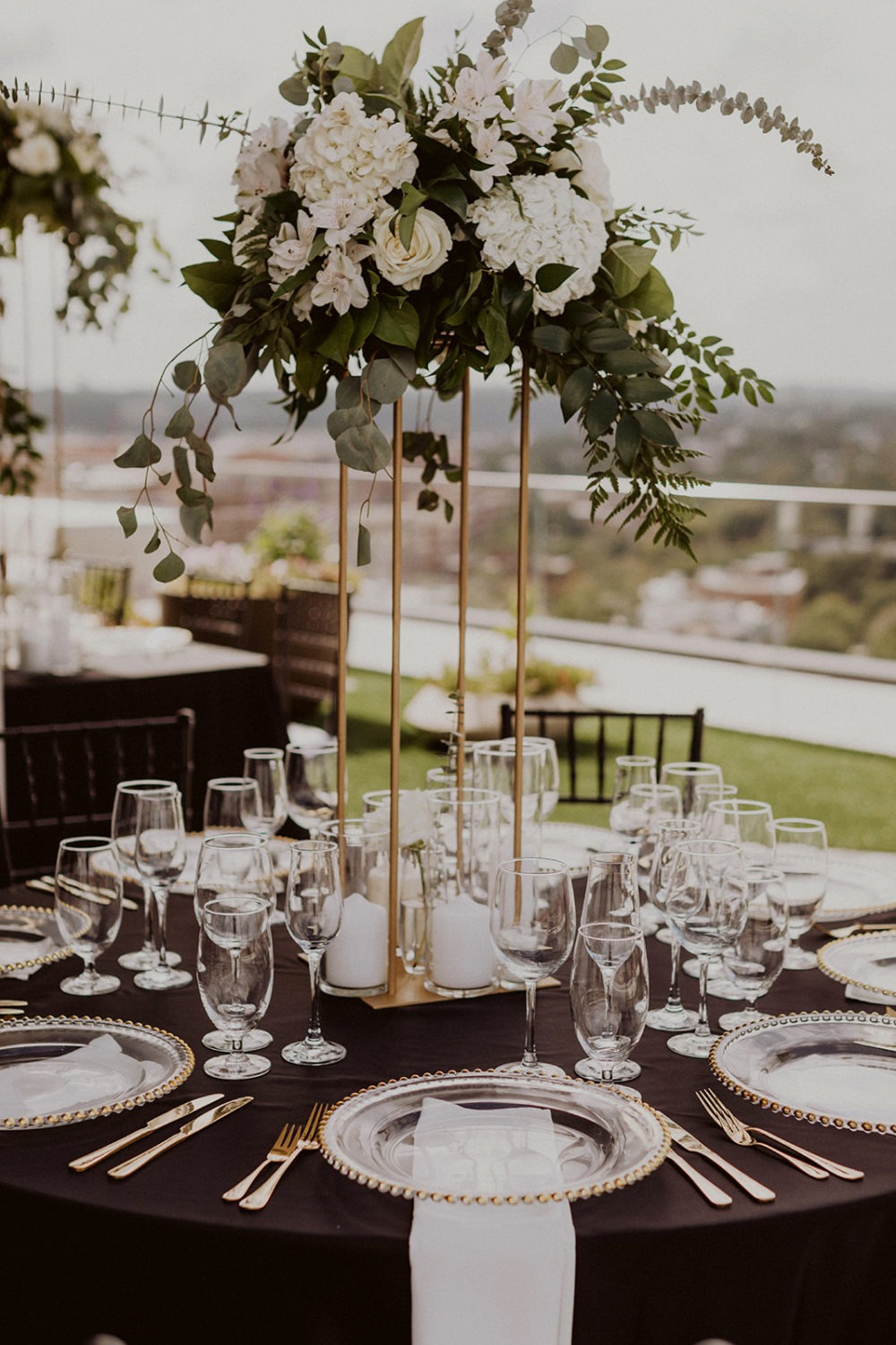 white flowers on gold decor with black tablecloth
