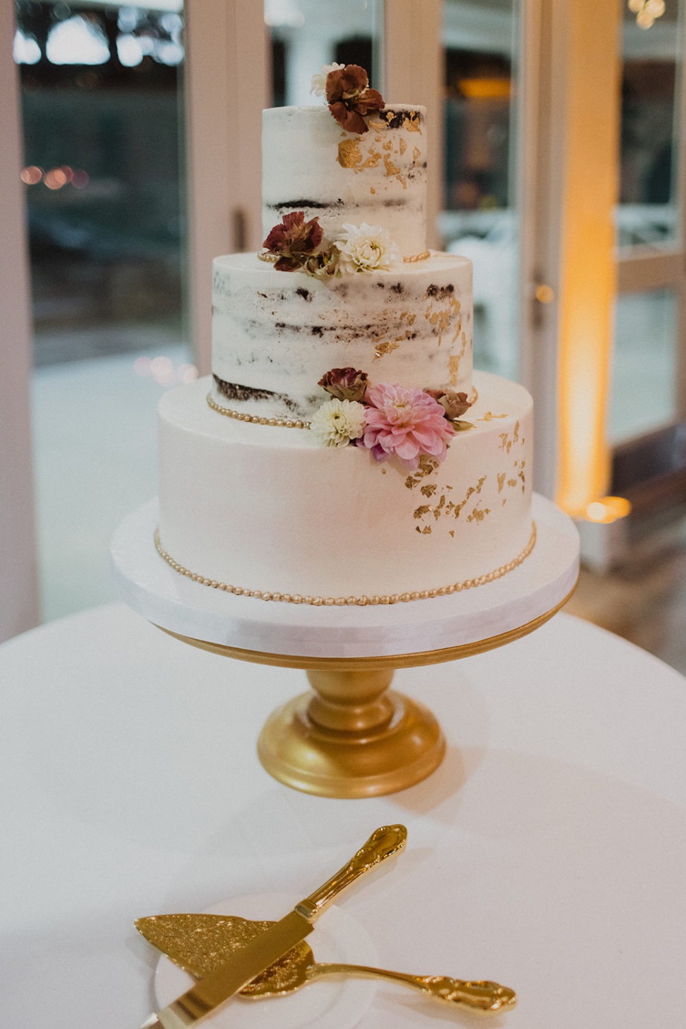 Wedding cake with florals and gold