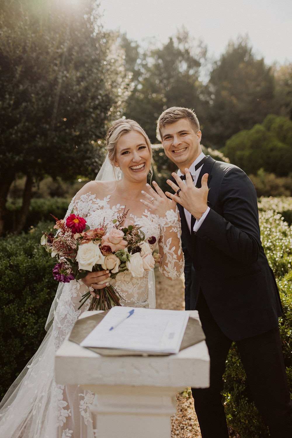 newlyweds show off rings right after wedding ceremony
