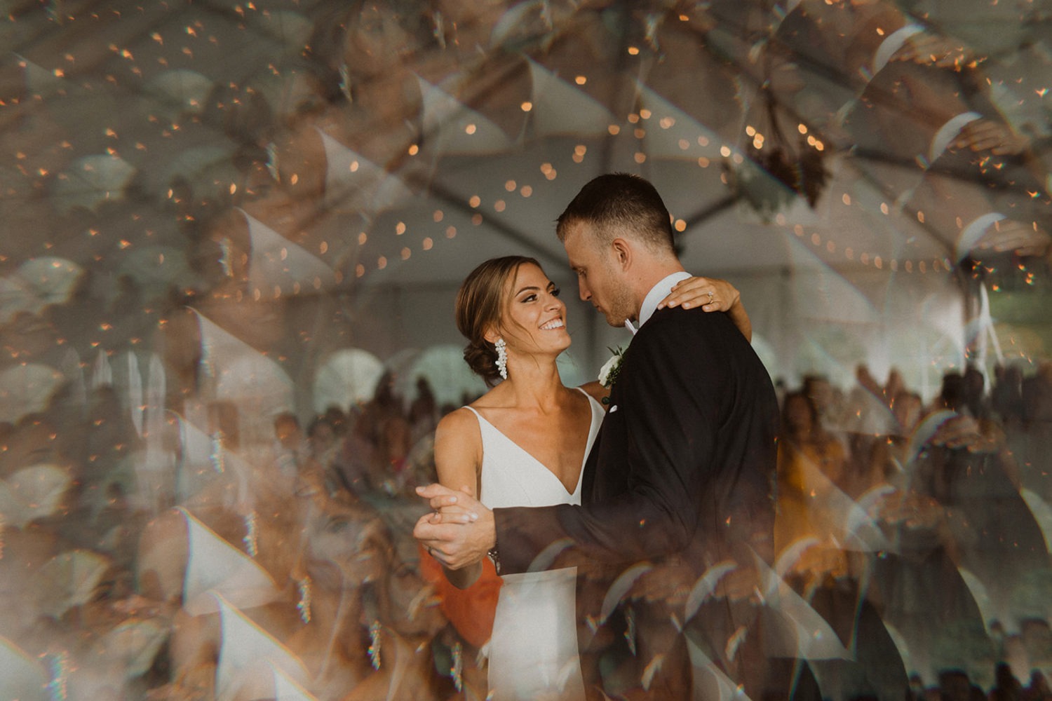couple dances in tented reception 