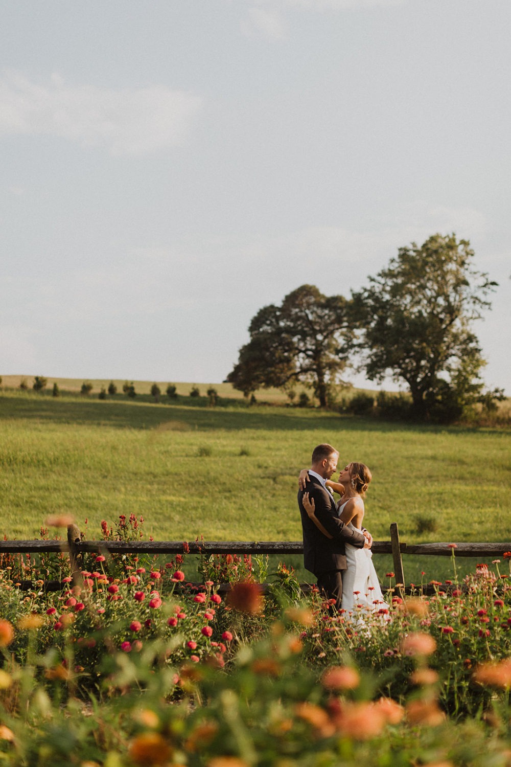 Couple embraces in wildflower garden at Glen Ellen Farms wedding